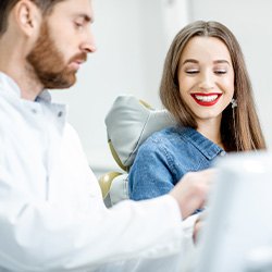 Dentist explaining cost of care to female patient