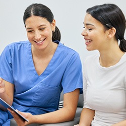 Dental team member and patient discussing ways to pay